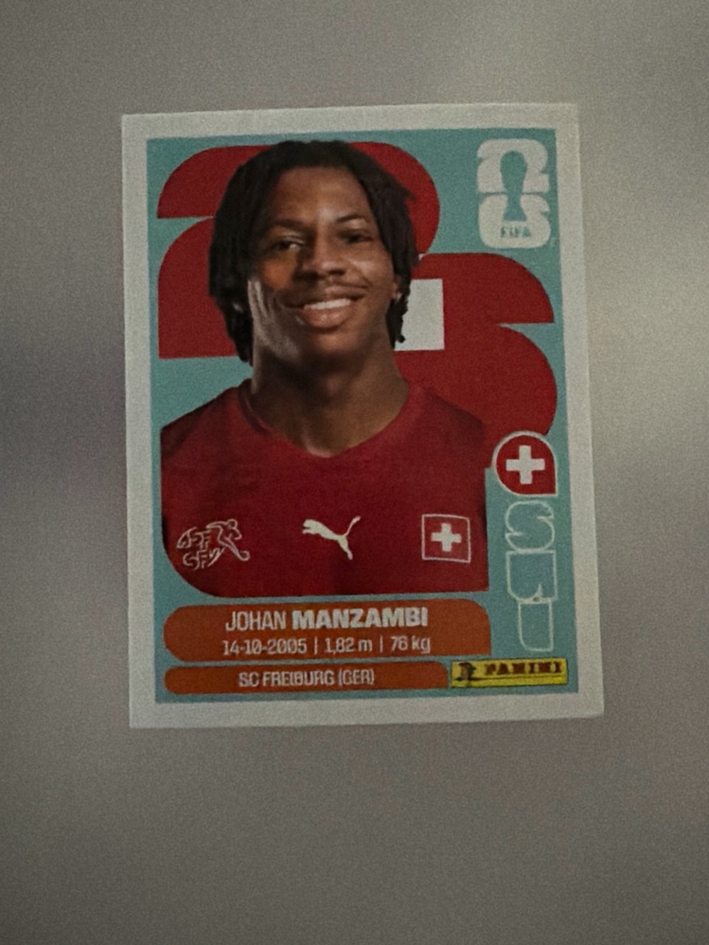 Panini Johan Manzambi Sticker - Red & Teal